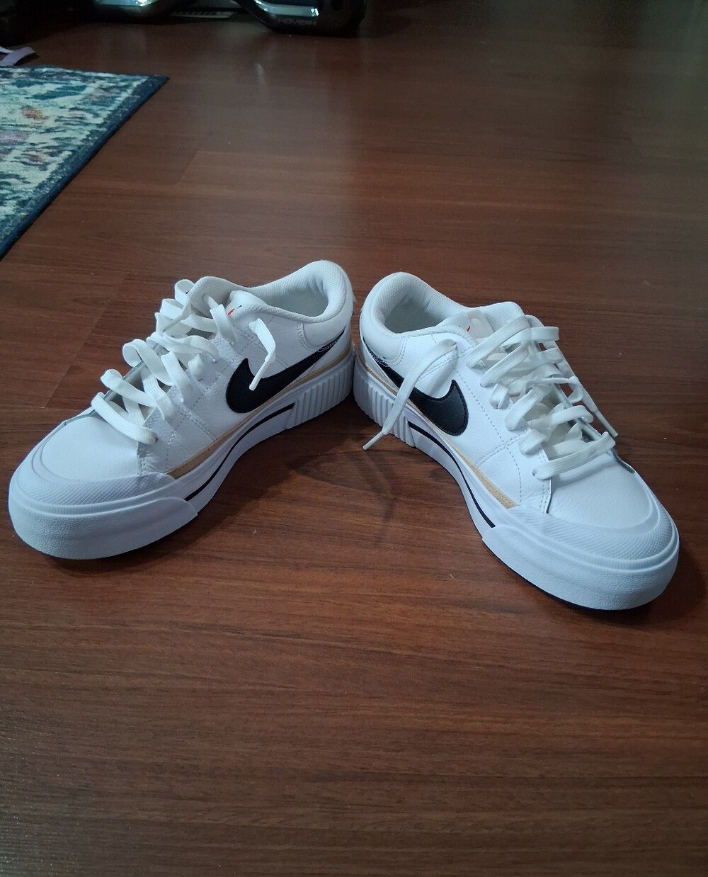 Nike Women's White Sneakers with Black Swoosh - Classic Low-Top